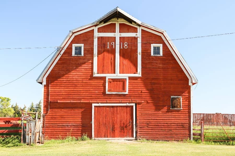 Bright red walled barn with light blue sky in background