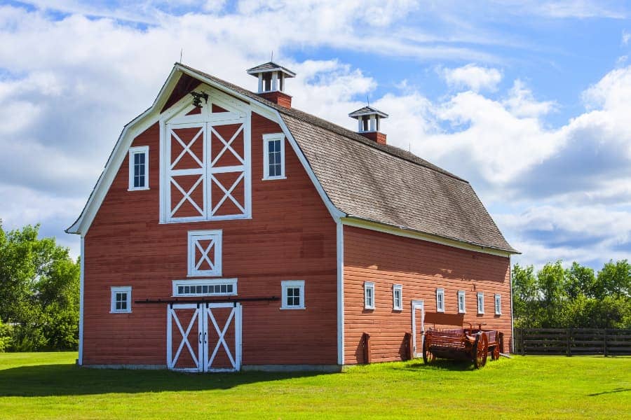 Red and white barn with blue sky in background